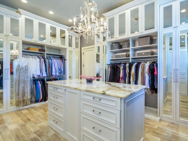Luxury walk-in closet with chandelier, in a high rise condo building in florida.