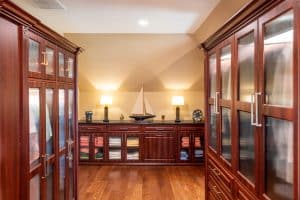 2nd story walk-in closet with dark wood units