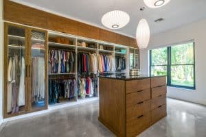 Walk-in closet with polished cement floor and island