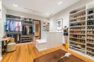 Walk-in closet with shoe shelves and island